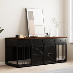 a dog crate with a mirror on top of it next to a window in a room