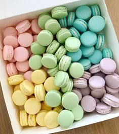 a box filled with lots of different colored macaroons