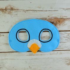 a blue bird mask with black eyes and nose