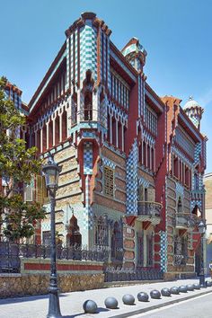 an ornate building with many windows and balconies on the front, along side a street light