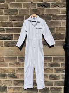 White Boilersuit Coveralls Deadstock- All In One - XS/small. Popper fronted 100% cotton boilersuits in white. Deadstock vintage items. - Popper fastenings - Elasticated back - 1 pocket to chest - 2 regular pockets to hip - 2 reach through pockets (typical of coveralls) - 1 pocket to rear - Straight leg SIZING TRUE MEASUREMENTS OF GARMENT XS - UK 6/8 Chest 36" - Waist 28" - Hips 38" Leg inseam length 30-31". Please allow 1-2" of variation between sets. The waist is elasticated at the rear so can White Overalls With Pockets, Vintage White Jumpsuits And Rompers For Spring, White Cotton Overalls With Relaxed Fit, White Overall Jumpsuits And Rompers With Pockets, White Utility Overalls With Pockets, White Overalls Jumpsuit With Pockets, White Jumpsuits And Rompers With Pockets For Work, White Long Sleeve Jumpsuit With Pockets, Fitted Long Sleeve Cotton Overalls