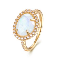 Introducing the Skye Moonstone Ring—a classic piece that features a genuine Rainbow Moonstone, beautifully framed by a halo of sparkling crystals on a pave band. Choose between luxurious 14k Gold Vermeil or elegant Sterling Silver, and let this naturally stunning gemstone captivate you with its unique charm. Each Rainbow Moonstone is handpicked for its individual beauty, ensuring that your ring is truly one-of-a-kind. Details:Gemstone: 9x11mm Genuine Rainbow MoonstoneRing Face (including crystal halo): 14mm x 11.8mmBand Width: 1.8mm Elevate your jewelry collection with the Skye Moonstone Ring—a perfect blend of elegance and enchantment. Elegant Yellow Gold Crystal Ring With Gemstone Accents, Elegant Yellow Gold Moonstone Ring With Round Stone, Elegant Gold Moonstone Moon Ring, Elegant Gold Moon-shaped Moonstone Ring, Gold Moon Shaped Elegant Ring, Elegant Gold Moon-shaped Ring, Elegant Moon-shaped Promise Ring Jewelry, Elegant Halo Moonstone Ring For Formal Occasions, Elegant Formal Moonstone Ring With Halo