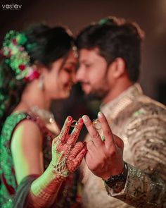 the bride and groom are holding their hands together