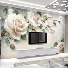 the living room is decorated with white roses and green leaves on it's wall