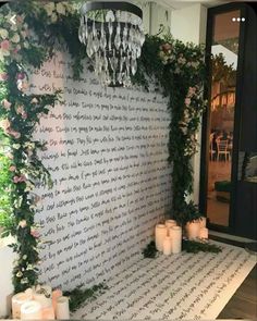 a wall with candles and flowers on it