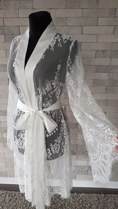 Off-white luxurious wedding robe, to add a perfect touch to your perfect and unique day. Only high quality fabrics and high finishing used for making the robe as neat as it can be. Please find the wedding robes collection here https://www.etsy.com/shop/LidiasBoutiqueDesign?ref=seller-platform-mcnav&section_id=25023222. For wedding dresses, please access https://www.etsy.com/shop/LidiasBoutiqueDesign?ref=seller-platform-mcnav§ion_id=23157290. For wedding tops and boleros, please access https: Feminine Lace Wedding Dress With Lace Sleeves, Lace Nightgown For Wedding Night, Elegant Lace Dress For Bridal Shower, Elegant Bridesmaid Lace Dress With Delicate Details, Elegant Long Fitted Sleepwear, Fitted Long Elegant Sleepwear, Elegant Nightgown With Delicate Lace For Wedding Night, Elegant Lace Nightgown, White Lace Nightgown For Wedding Night