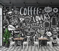 a black and white coffee shop with chalk drawings on the wall