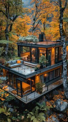 an aerial view of a house surrounded by trees and foliage in the fall with autumn colors