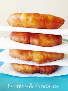 three donuts stacked on top of each other with the words pennies & pancakes written below them