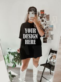 a woman taking a selfie in front of a mirror wearing white boots and a black t - shirt