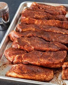 some meat is laying on a baking pan