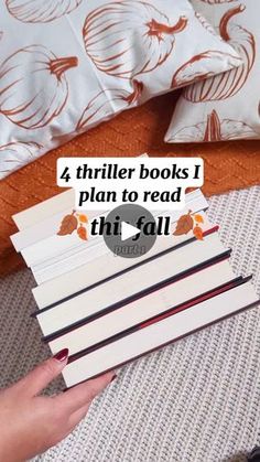 a person is holding several books on top of each other with the text 4 thirler books i plan to read this fall