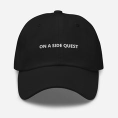 On A Side Quest embroidered Dad hat, Video Game Hat, Ironic Gamer hat, Gamer Hat Dad hats aren't just for dads. This one's got a low profile with an adjustable strap and curved visor. * 100% chino cotton twill * Green Camo color is 35% chino cotton twill, 65% polyester * Unstructured, 6-panel, low-profile * 6 embroidered eyelets * 3 ⅛" (7.6 cm) crown This product is made especially for you as soon as you place an order, which is why it takes us a bit longer to deliver it to you. Making products Cheap Funny Cap Style Hat, Funny Streetwear Hats One Size, Weird Baseball Caps, Funny One-size Streetwear Hats, Funny Baseball Hat, Embroidered Ideas, Cool Dad Hats, Side Quest, Embroider Ideas