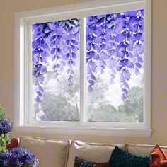 a living room with two windows covered in purple flowers