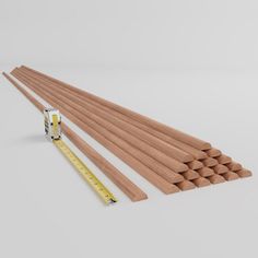 wooden dowels and measuring tape on white background