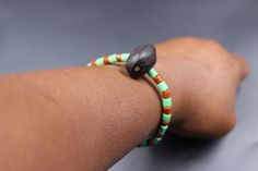 This bracelet symbolizes life, love, balance, respect for nature, and spiritual/physical growth. Its colours represent the following in Ifá (Yorùbá spirituality): ➞ Green: The colour of nature and a symbol of Ọ̀rúnmìlà's relationship with Ọ̀sanyìn, who engaged deeply in the study of plants and herbs, and through whom many discoveries were made, to Ọ̀rúnmìlà's advantage as a diviner and healer. ➞ Brown: The colour of the earth, devotion, groundedness, discipline and balance. It is a symbol of Ọ̀rúnmìlà's love for Apẹ̀tẹ̀bí, his wife, and a reminder of the importance of women in spiritual affairs. It represents Apẹ̀tẹ̀bí's diligence, sacrifice and complete devotion to Ifá-Ọ̀rúnmìlà. She spent the better part of her life receiving her husband's visitors, nurturing them to health, preparing/ Study Of Plants, Yoruba Language, The Study, Beautiful Packaging, Green And Brown, Jewelry Bracelets, Beaded Bracelets, Bracelet, Beads