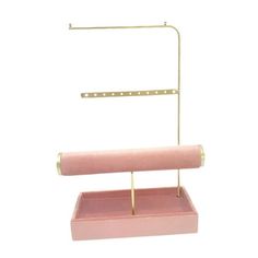 a pink and gold stand with a roll of toilet paper on it's holder