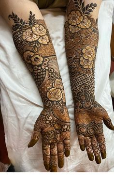 two hands with henna tattoos on them