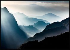 the sun shines brightly through the clouds in the mountain range as it peeks over the mountains