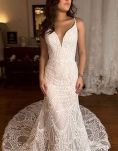 a woman in a wedding dress standing on a doily with her hands behind her back