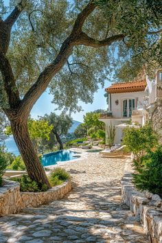 a stone path leading to a house with an outdoor swimming pool