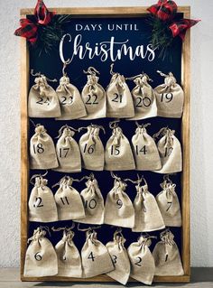 a christmas bag hanging from the side of a wooden frame with numbers and bells on it