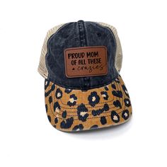 HOLIDAY DEADLINE: ORDERS PLACED AFTER DECEMBER 15th will NOT arrive in time for Christmas Engraved leatherette patch hat is engraved with "Proud Mom of All These Crazies" in a cute trendy script & block font. Available in 3 color options:  ✅ Pink (black/white polka dots underneath) ✅ Black/White Polka Dots (denim underneath) ✅ Black/Brown Leopard Print with Tan Mesh Back (leopard print underneath) These hats are premium Infinity brand 100% cotton, pigment-dyed twill -  Unstructured, six-panel, l Ponytail Hats, Mama Hat, Leopard Hat, Leather Patch Hat, Mom Hat, Block Font, Mom Hats, Patch Hat, Ponytail Hat