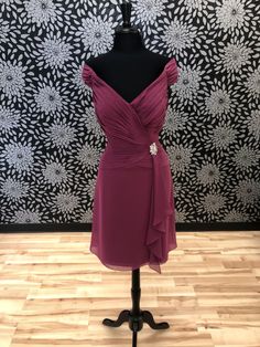 a dress on a mannequin in front of a wall