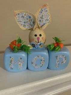 a bunny sitting on top of blocks with carrots in the shape of numbers 10