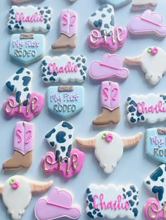 decorated cookies are arranged in the shape of cowgirl boots and boots with name tags