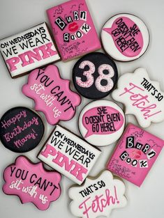 decorated cookies with pink and black frosting on them