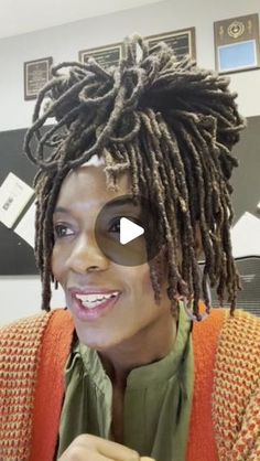 a woman with dreadlocks sitting in an office