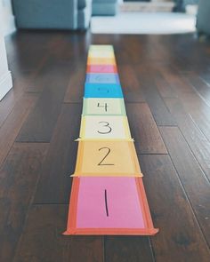 a number line on the floor that is numbered with different colors and numbers for each letter