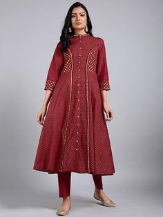 A red princess line kali kurta with 3/4th sleeves, hand block printed in gold, and details in gota. Features: Front open jacket dress with 3/4th sleeves Shell - pure cotton fabric Block printed in gold Side kali flare from waist to hem Handmade in India Measurements: Size XS : Bust-34", Waist-29", Hip-Flared, Shoulder-13", Length-47", Sleeve length-17" Size S : Bust-36", Waist-31", Hip-Flared, Shoulder-13.5", Length-47", Sleeve length- 17" Size M : Bust-38", Waist-33", Hip-Flared, Shoulder-14", Festive Kurta With Printed Motifs And 3/4 Sleeves, Festive Kurta With 3/4 Sleeves And Printed Motifs, Festive 3/4 Sleeve Kurta With Printed Motifs, Gold Long Sleeve Dresses With Gota Work, Festive Kurta With 3/4 Sleeves, Festive Kurta With 3/4 Sleeve For Eid, Festive 3/4 Sleeve Kurta For Eid, Traditional 3/4 Sleeve Kurta For Diwali, Red Chanderi Kurta With Bandhani Print