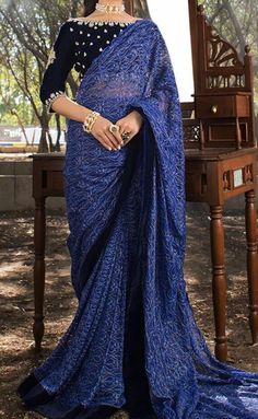 Product Description:  A perfect shade of blue draped Chantilly saree comes with a navy blue velvet blouse, which is exquisitely adorned with floral motif on the sleeves, followed by intricate border on sleeves and neckline. Color: Navy Blue Includes:  Chantilly Saree  Velvet Blouse Elegant Blue Pre-draped Saree, Formal Blue Draped Saree, Blue Formal Pre-draped Saree, Formal Blue Pre-draped Saree, Blue Georgette Draped Saree, Traditional Blue Blouse Piece For Evening, Blue Traditional Drape Blouse For Evening, Traditional Drape Blue Blouse Piece For Evening, Elegant Pre-draped Saree With Chikankari Embroidery For Navratri