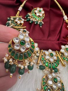 Jadau Kundan Green Floral Necklace with matching EarringsColor : GoldenSize : Necklae Length : 16 Inches; Earrings Length : 1.5 InchesStones : Jadau Kundan Pearls Traditional Round Kundan Necklace With Stones, Traditional Kundan Jewelry With Stones, Traditional Festival Earrings With Stones, Green Hand Set Round Chandbalis, Kundan Earrings With Stones For Celebration, Kundan Earrings With Stones For Wedding, Green Temple Jewelry Sets With Latkans, Kundan Chandbali Jewelry With Stones, Festive Green Kundan Necklace With Matching Earrings