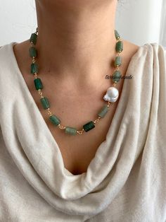 "This exquisite gold-plated necklace features natural aventurine stones and boasts a refined design. The necklace showcases vibrant green hues and unique textures of the aventurine stones, creating a striking appearance. On one side of the necklace, there is a natural baroque pearl. This pearl, with its irregular yet elegant shape and natural luster, adds sophistication and complements the other stones perfectly. The necklace is crafted with wire, offering a modern aesthetic while ensuring the proper placement of the stones and pearl. It measures 18 inches (46 cm) in length, with an additional 1-inch (3 cm) extension chain for adjustable fitting. This elegant necklace is versatile for both day and night wear and pairs beautifully with a variety of outfits." Gold Aventurine Beaded Necklaces, Bohemian Gold Aventurine Necklace, Gold Aventurine Necklaces For Healing, Gold Aventurine Necklace With Gemstone, Gold Aventurine Gemstone Necklace, Spiritual Gold Aventurine Necklace, Spiritual Aventurine Gold Necklace, Collar Verde, Unique Textures