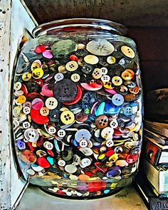 a jar filled with lots of different colored buttons