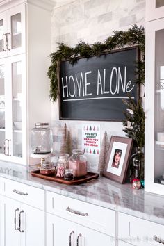 a kitchen counter topped with lots of christmas decorations and decorating on top of it