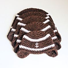 a crocheted hat with white stripes on it