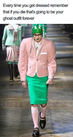 a man in a pink jacket and green skirt walking down a runway with text that reads, every time you get dressed remember that if you die that's going to be your ghost