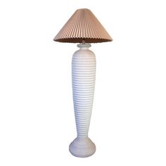 a white table lamp with a beige shade on it's base and a brown corded lampshade