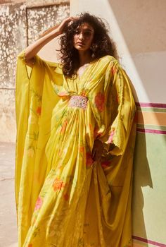 Introducing the lime yellow kaftan set, crafted from placement printed pure habutai silk fabric, where the print is meticulously placed to enhance the extraordinary look of this modern silhouette. Adorned with hand-embroidered patches and delicate details on the sleeves and neck, this silhouette offers a relaxed and super comfy look, perfect for embracing both style and comfort. Spring Silk Kaftan With Printed Motifs, Yellow Floral Print Kurta, Yellow Silk Sets With Printed Motifs, Summer Designer Kurta With Digital Print, Summer Designer Digital Print Kurta, Summer Festive Saree-shaped Kaftan, Yellow Bollywood Style Floral Kurta, Yellow Silk Sets With Floral Print, Traditional Yellow Kaftan For Festive Occasions