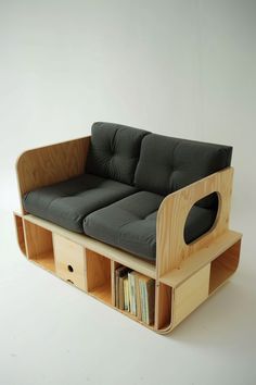 a couch that is made out of wood and has bookshelves on the bottom