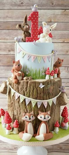 a three tiered cake decorated with woodland animals