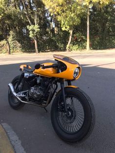 a yellow motorcycle parked on the side of the road