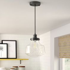 a light fixture hanging from the ceiling in a kitchen