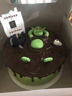 there is a cake in the box that looks like it was made to look like an alien