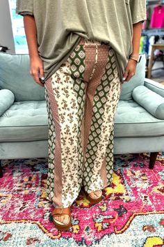 Unleash your inner babe with the NAOMI Wide Leg Pants in Olive. These flowy pants are perfect for these transitional days, with a light weight design that keeps you cool and comfortable. The pattern adds a touch of whimsy to your wardrobe. Step into these stylish pants and let your free-spirited energy shine! Model is wearing a small and 2X. Material: 100% Rayon Sizing: Small: 2/4 Medium: 6/8 Large: 10/12 Summer Printed Loungewear Pants, Summer Printed Pants For Loungewear, White Rayon Bottoms For Vacation, Flowy Boho Print Bottoms For Spring, Casual Boho Print Pants For Vacation, Bohemian Patterned Bottoms For Vacation, Bohemian Style Flowy Bottoms With Floral Print, Bohemian Flowy Bottoms With Floral Print, Flowy Bohemian Bottoms With Floral Print