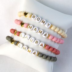 four bracelets with the words roma and roma written in gold on each bead